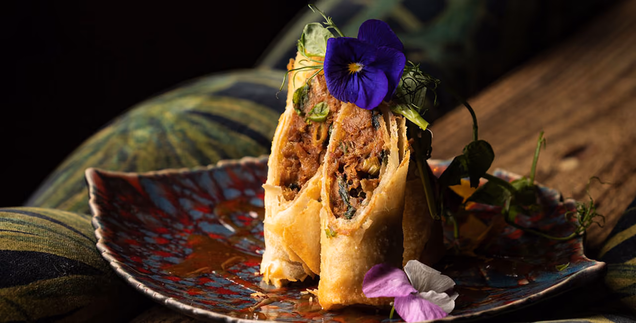 A plated dish at Mama Yo garnished with a flower