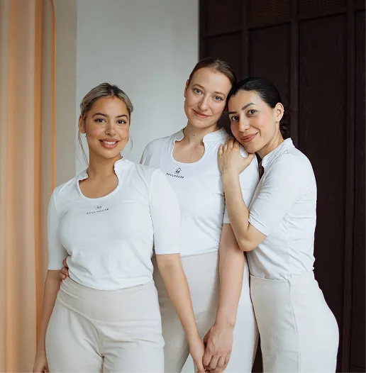 Gruppenbild von 3 Soulhouse Expertinnen in weißen Shirts stehen eng beieinander und lächeln freundlich.