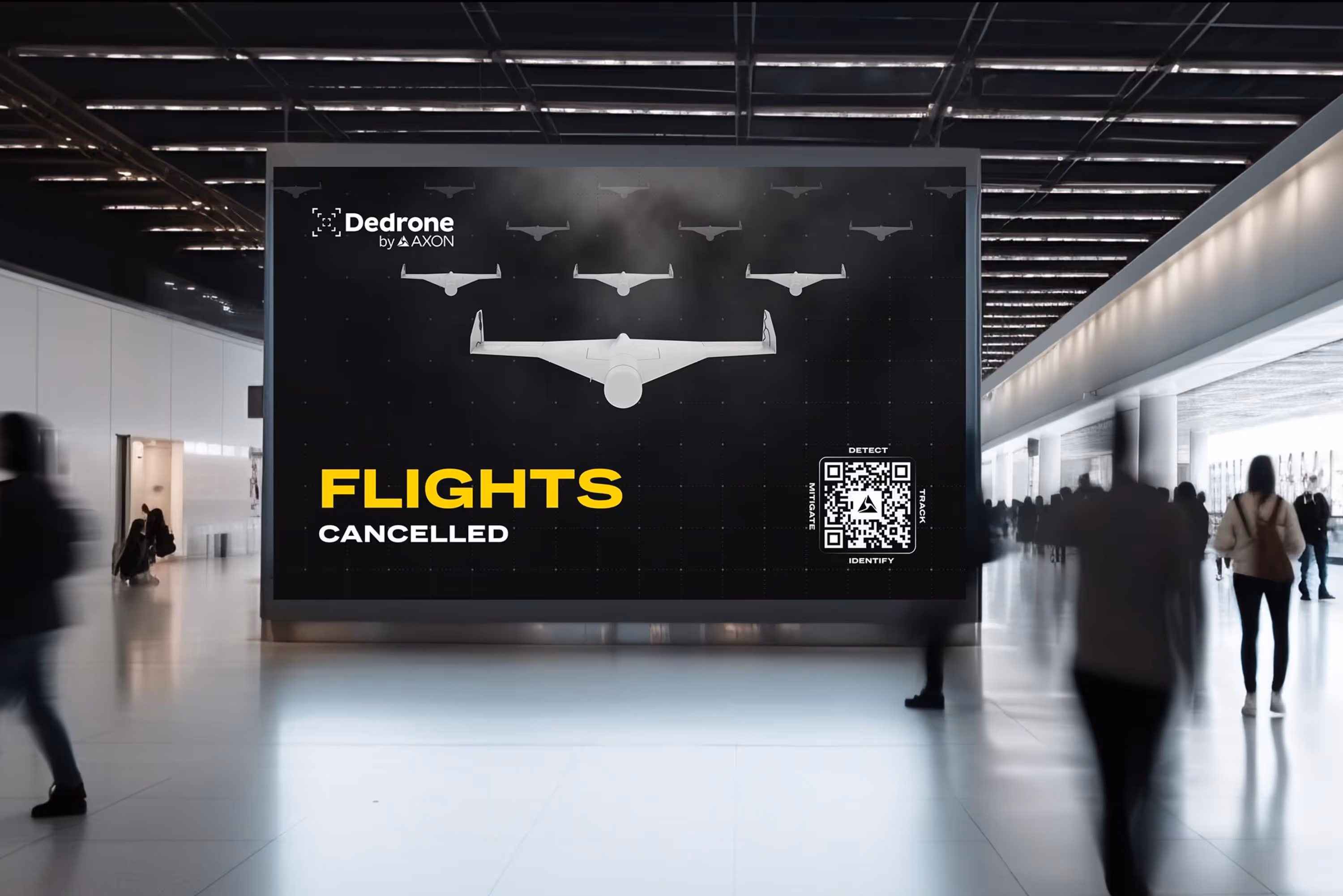 Airport terminal with large digital billboard displaying a Dedrone by Axon ad showing drones and the text 'FLIGHTS CANCELLED' with a QR code.