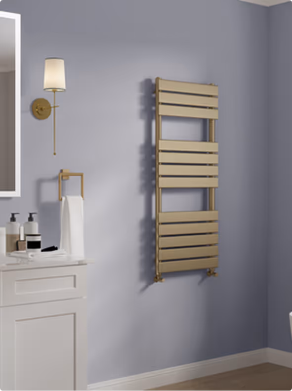 Modern bathroom wall with a white vanity, a brass towel holder with a white towel, a brass wall sconce, and a gold horizontal slat heated towel rail.