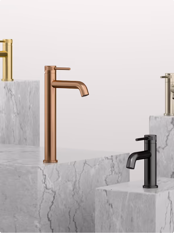 Four modern bathroom faucets in gold, copper, black, and brushed nickel finishes displayed on white marble blocks.