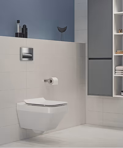 Modern bathroom with a wall-mounted toilet, toilet paper holder, and a grey cabinet with shelves holding towels and toiletries.
