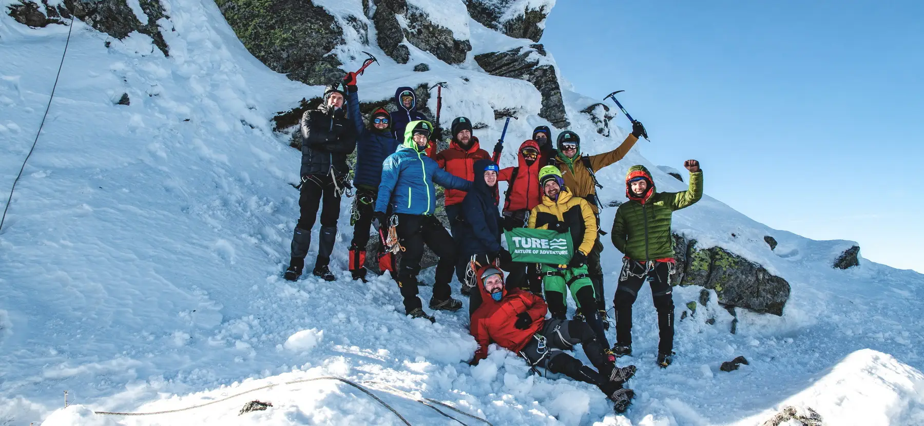Group of tourists on a mountain peak during a TURE active tour