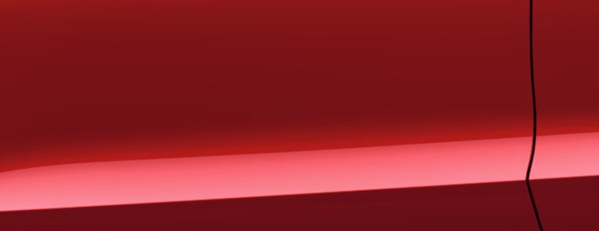 Eine minimalistische Detailaufnahme zeigt einen Ausschnitt der Karosserie des Škoda Scala Balance in der Lackierung Velvet-Rot Metallic. 
