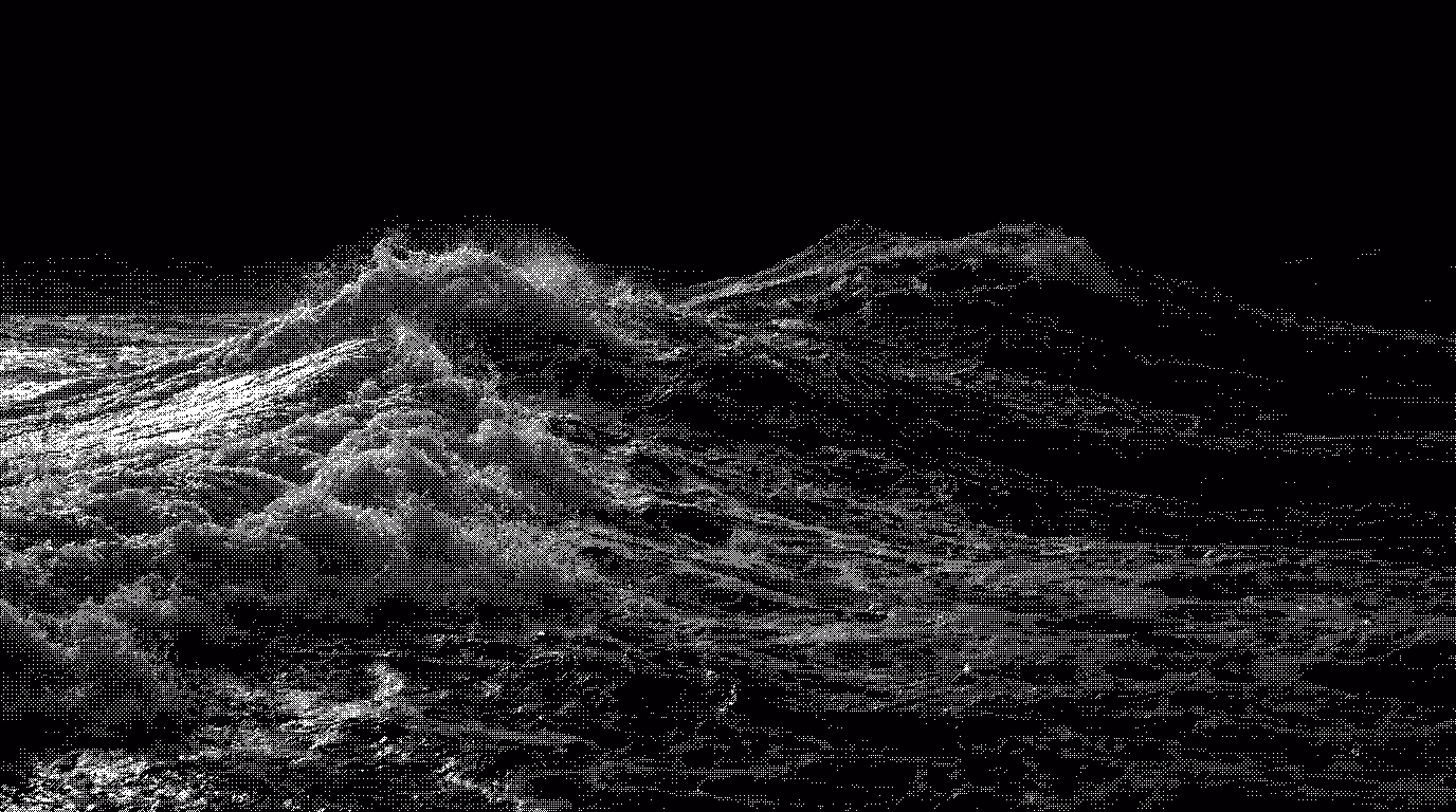 Black and white image of ocean waves crashing with visible foam and movement.