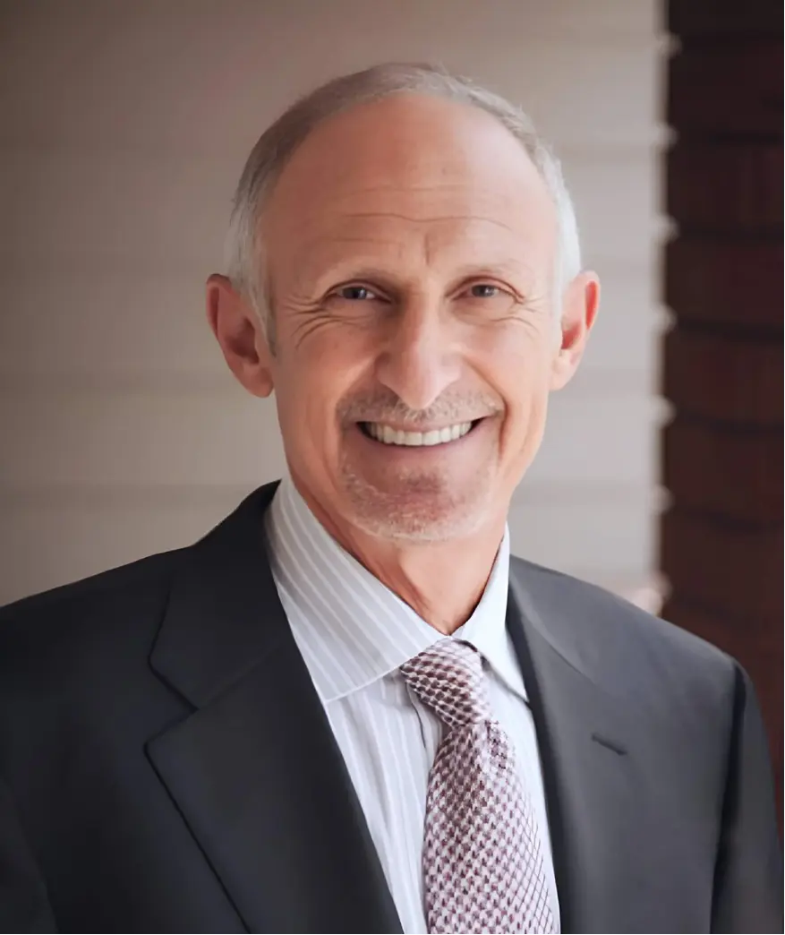 Ron Beck, Managing Partner, smiling in professional business suit with 95% case success rate and 45+ years of legal experience