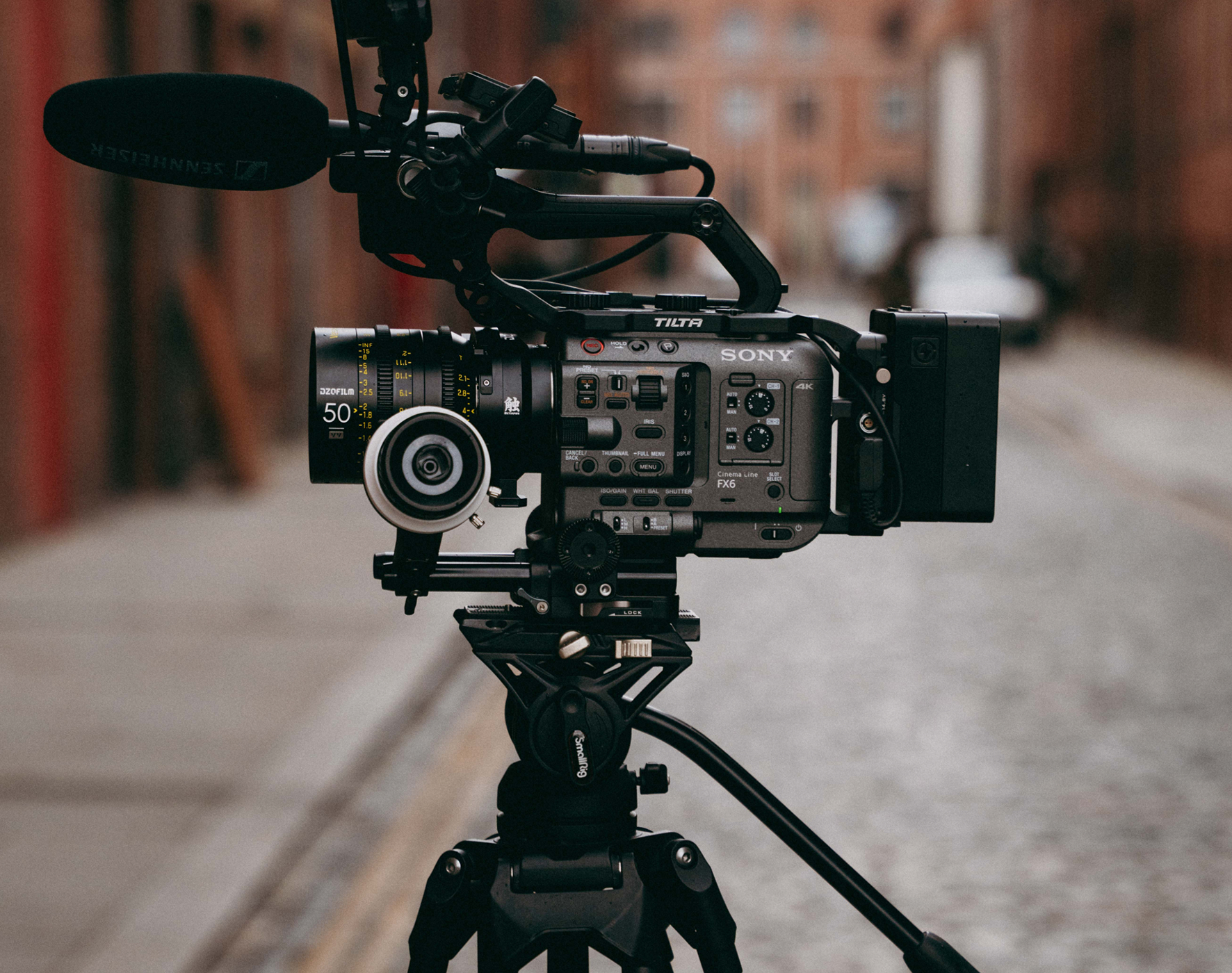 Professional Sony Cinema Line FX6 video camera with lens and microphone mounted on a tripod.