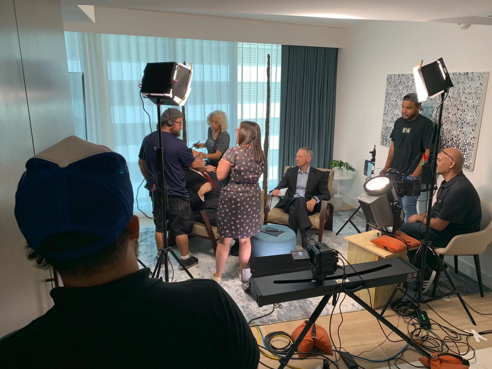 Behind-the-scenes of a TV commercial shoot with crew setup.