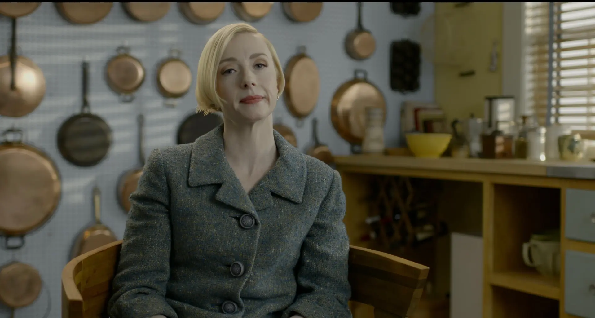 Actor delivering an on-camera interview in a kitchen set for a tv commercial scene.