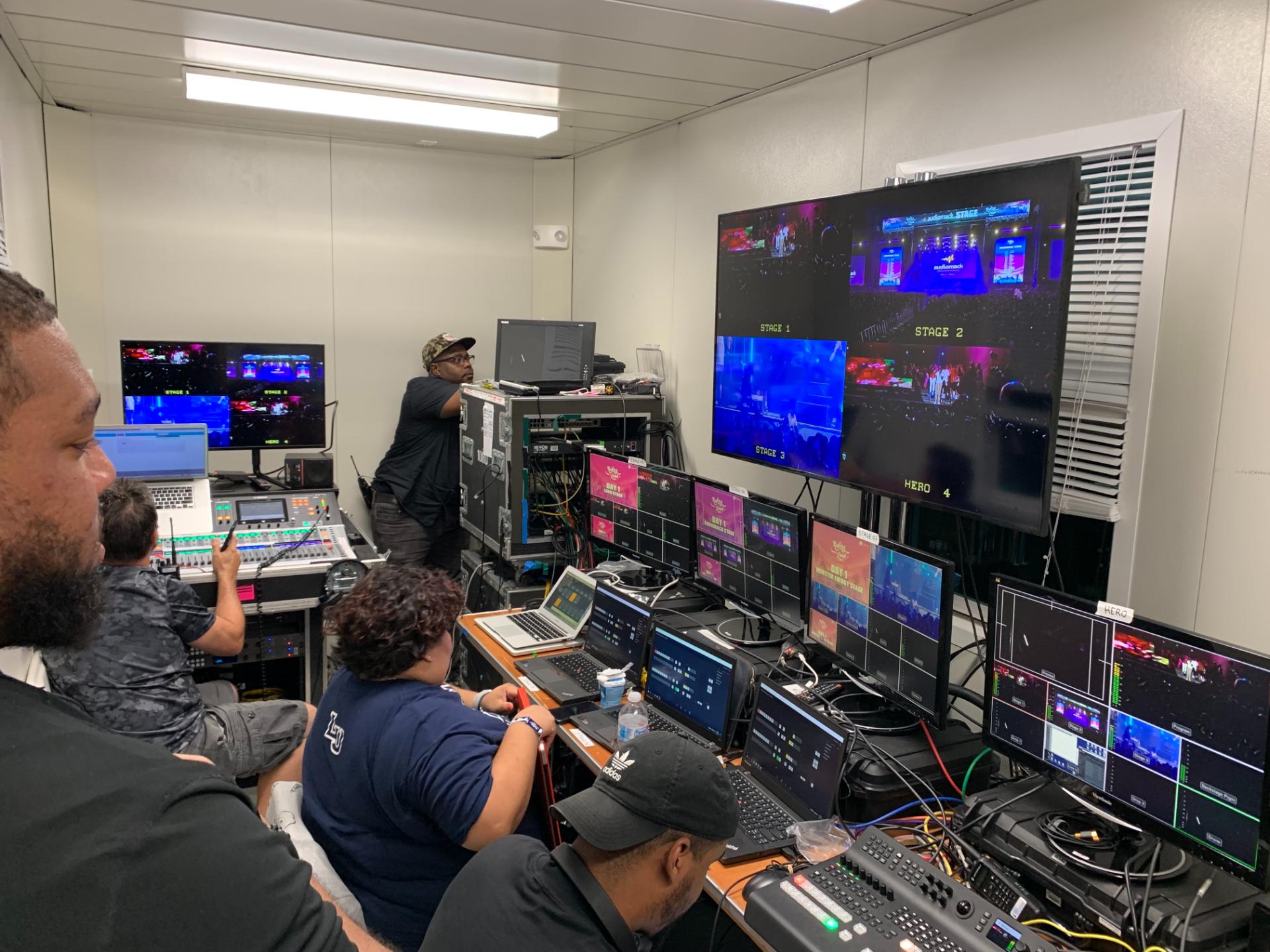 TV control room with multiple screens and crew managing live production.