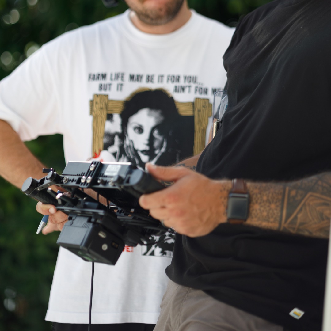 Crew operating professional camera stabilizer, highlighting advanced video production