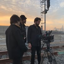 Video production Tampa crew filming on railway tracks at sunset