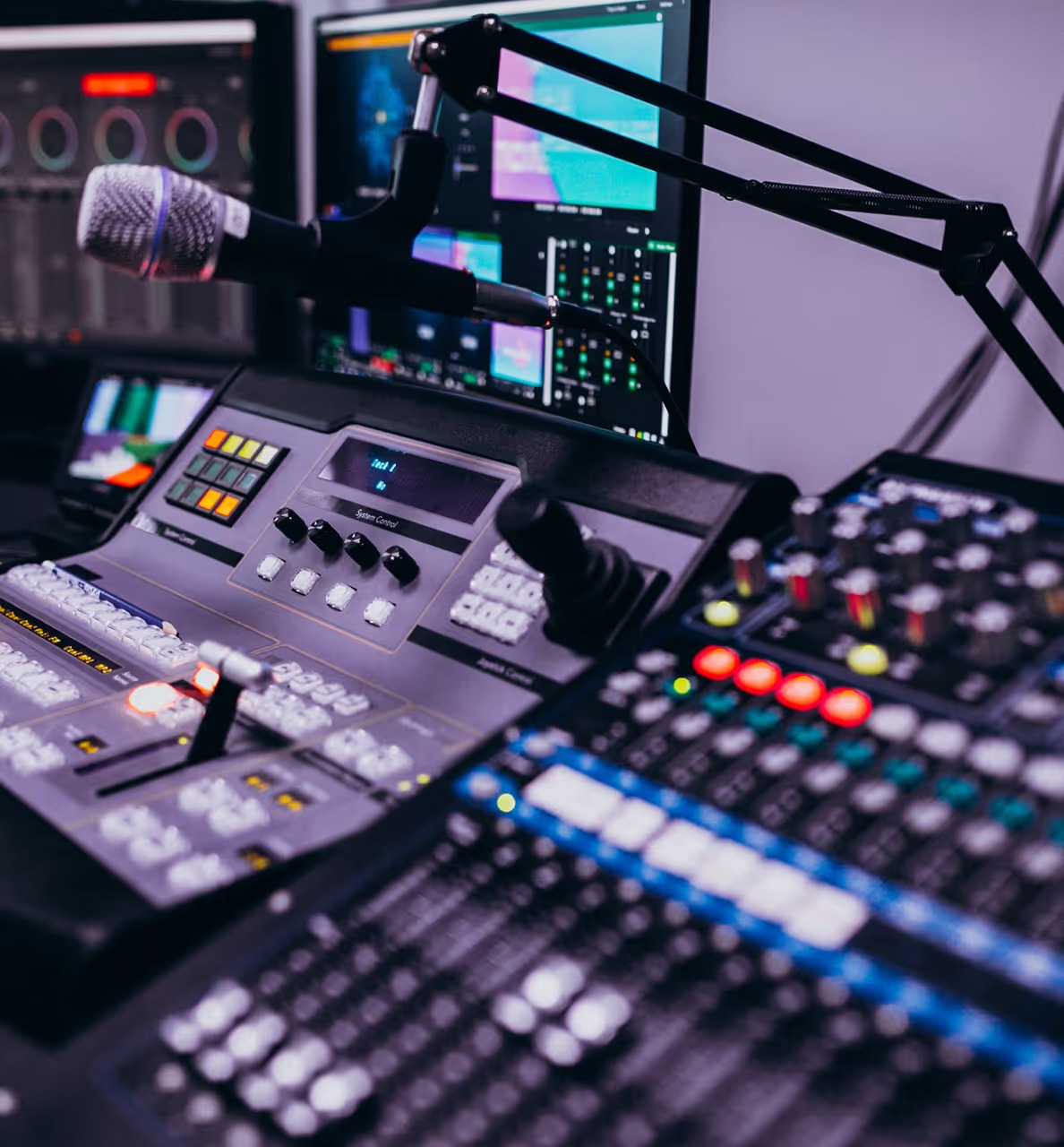 Close-up of a professional video production mixing console with microphone in a broadcast studio