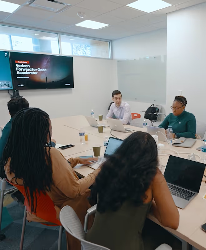 Team meeting discussing Verizon Forward for Good Accelerator.