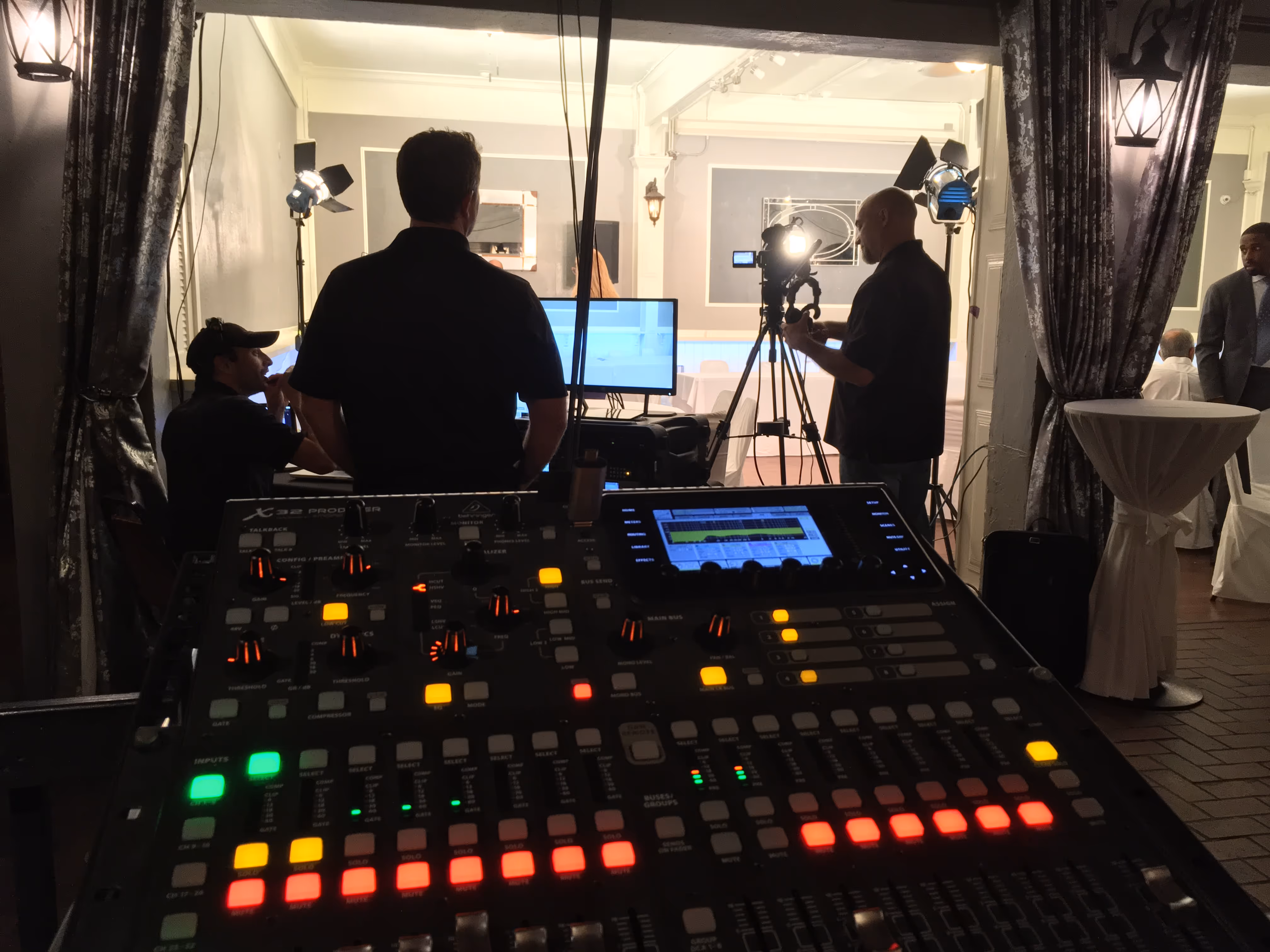 Audio mixing console at a live event production setup.