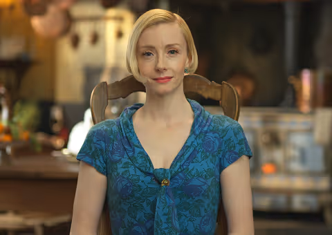 Woman in blue floral dress on TV commercial set