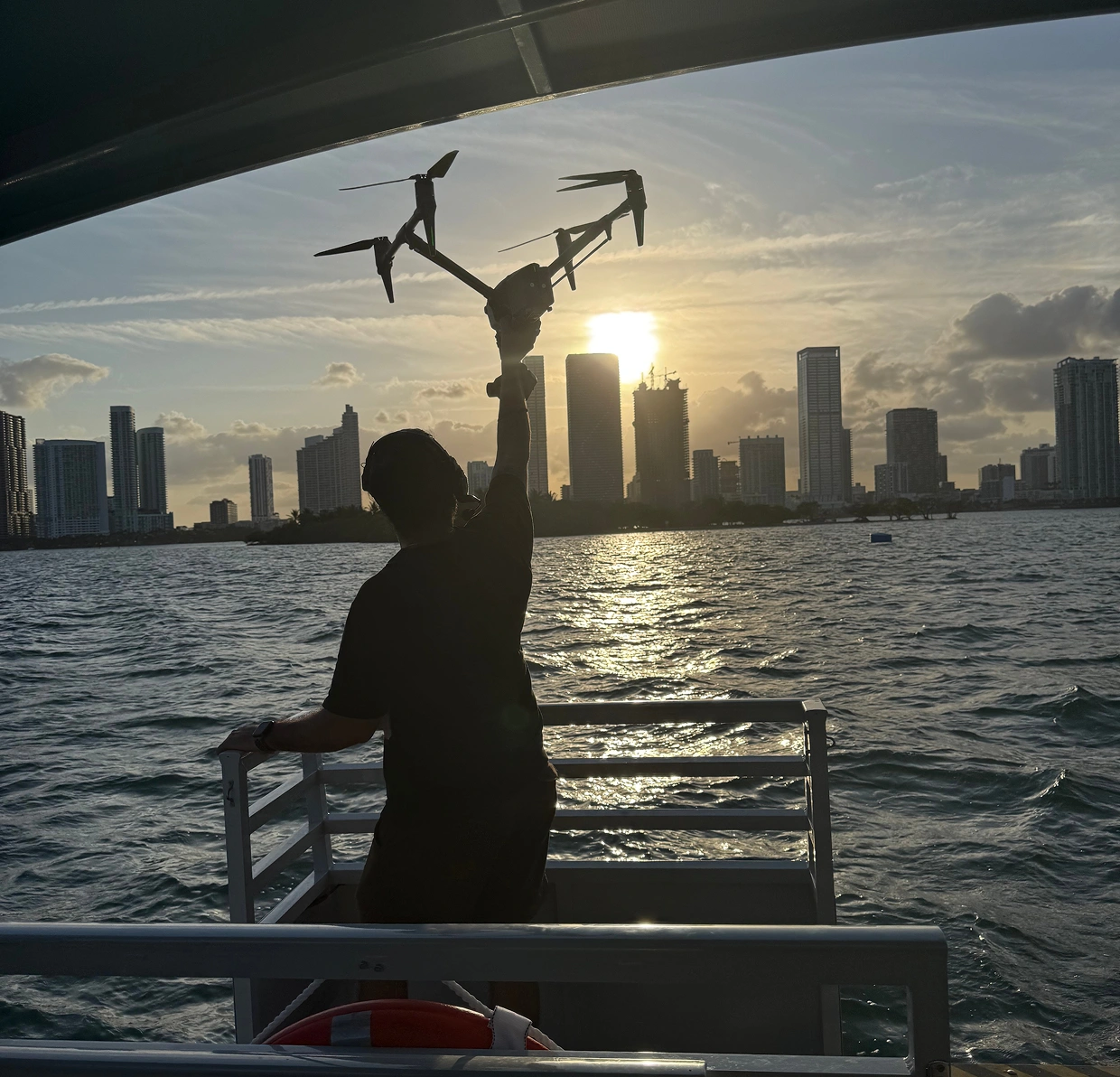 Drone filming a city skyline at sunset for AI video production.