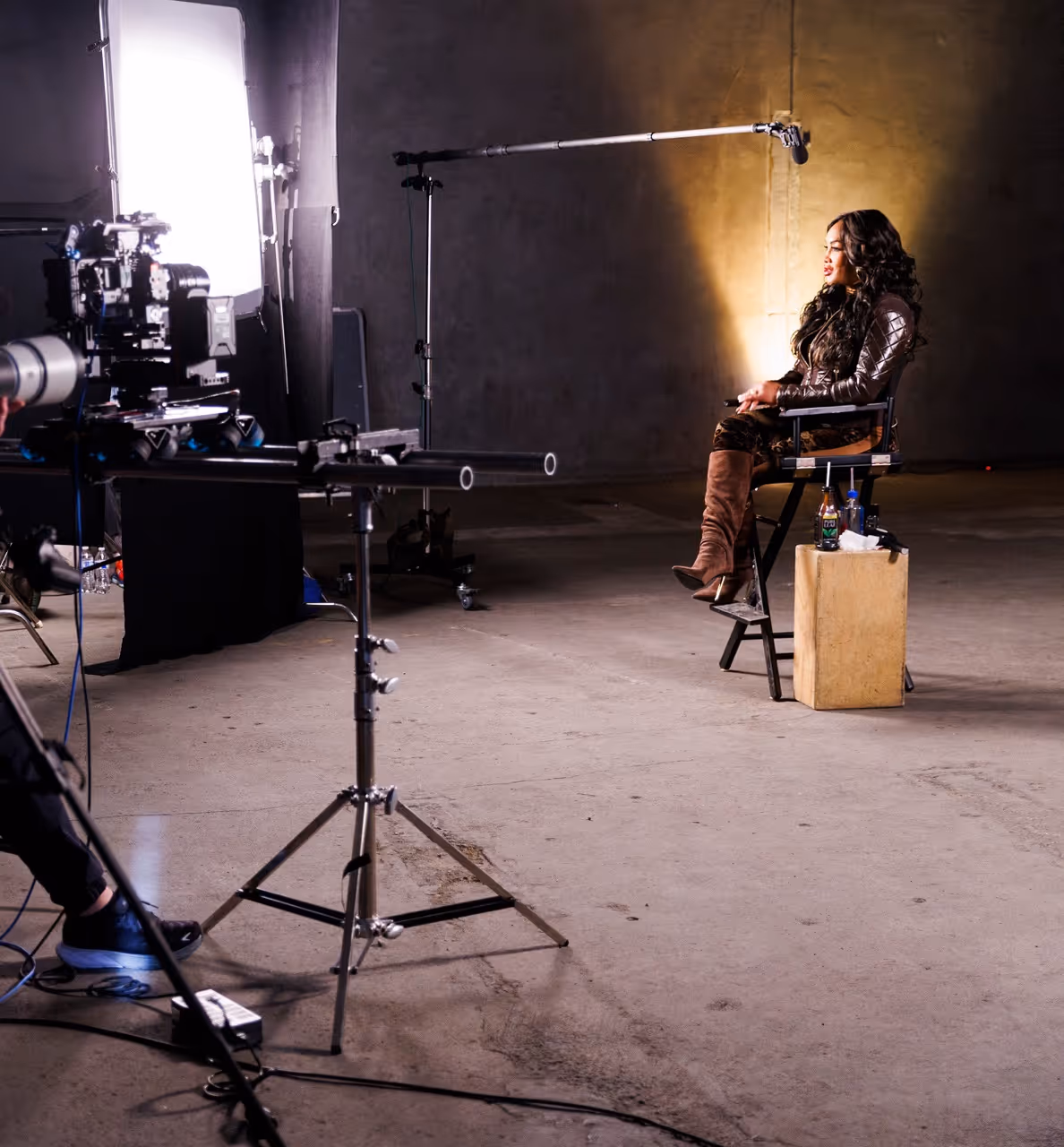 Behind-the-scenes lighting and camera setup for a corporate interview shoot in a studio