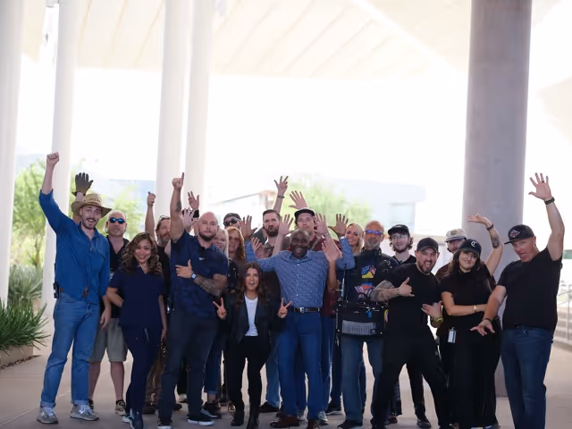 Full corporate video production crew celebrating after completing a shoot on location