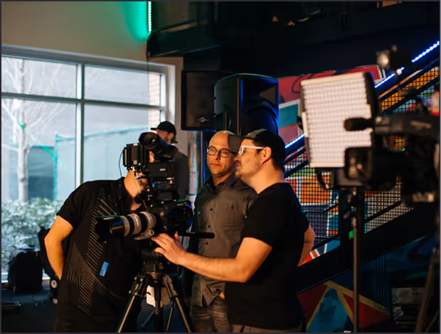 Crew framing a camera shot for a corporate interview video
