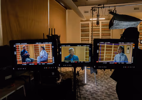 Camera monitors showing an interview setup on a company culture video shoot