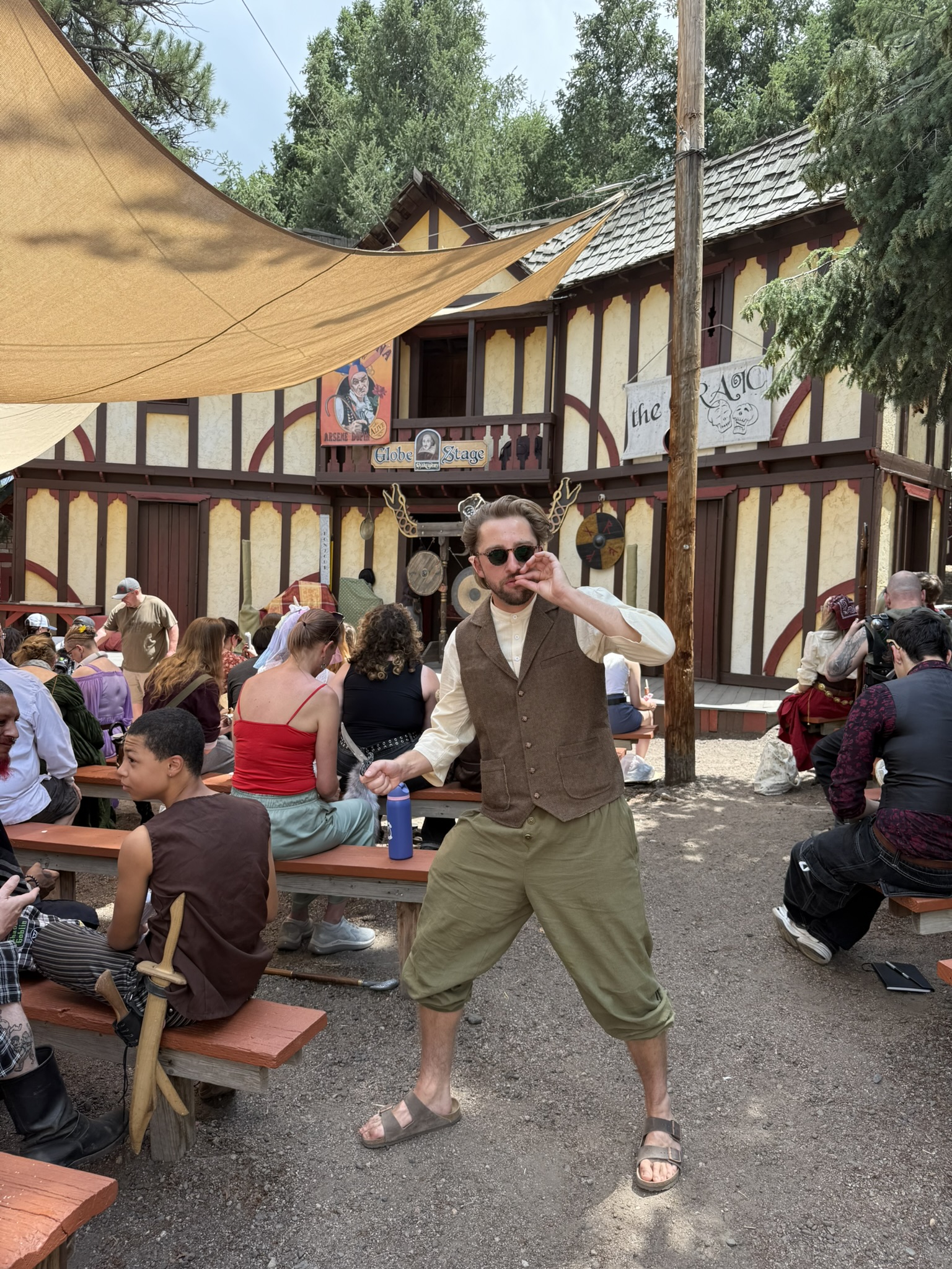 Dylan wearing a vest and sunglasses at a Renaissance fair.