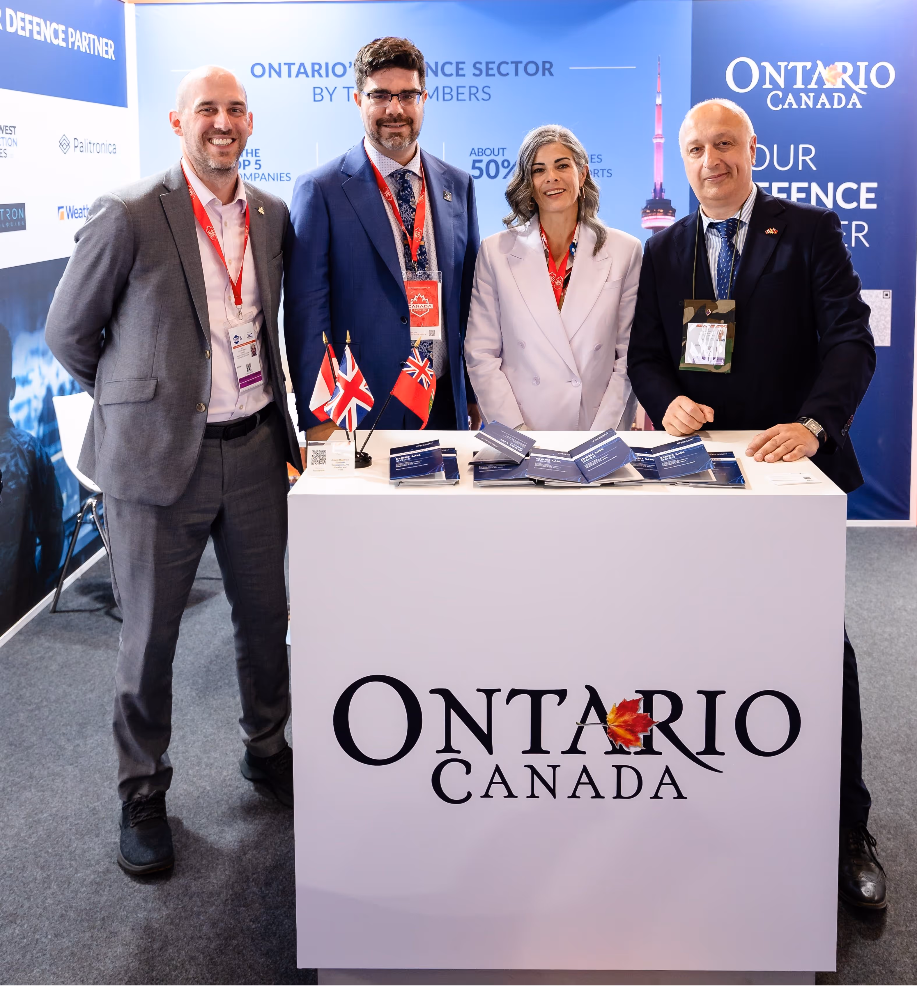 Busy CANSEC trade show floor with defence industry professionals networking among exhibition booths.