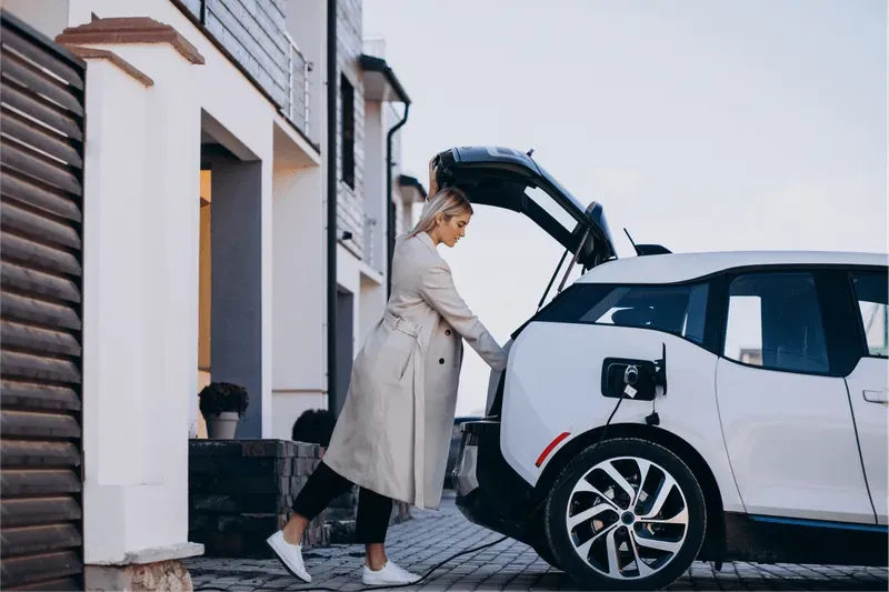 Woman loading the trunk of an EV car.