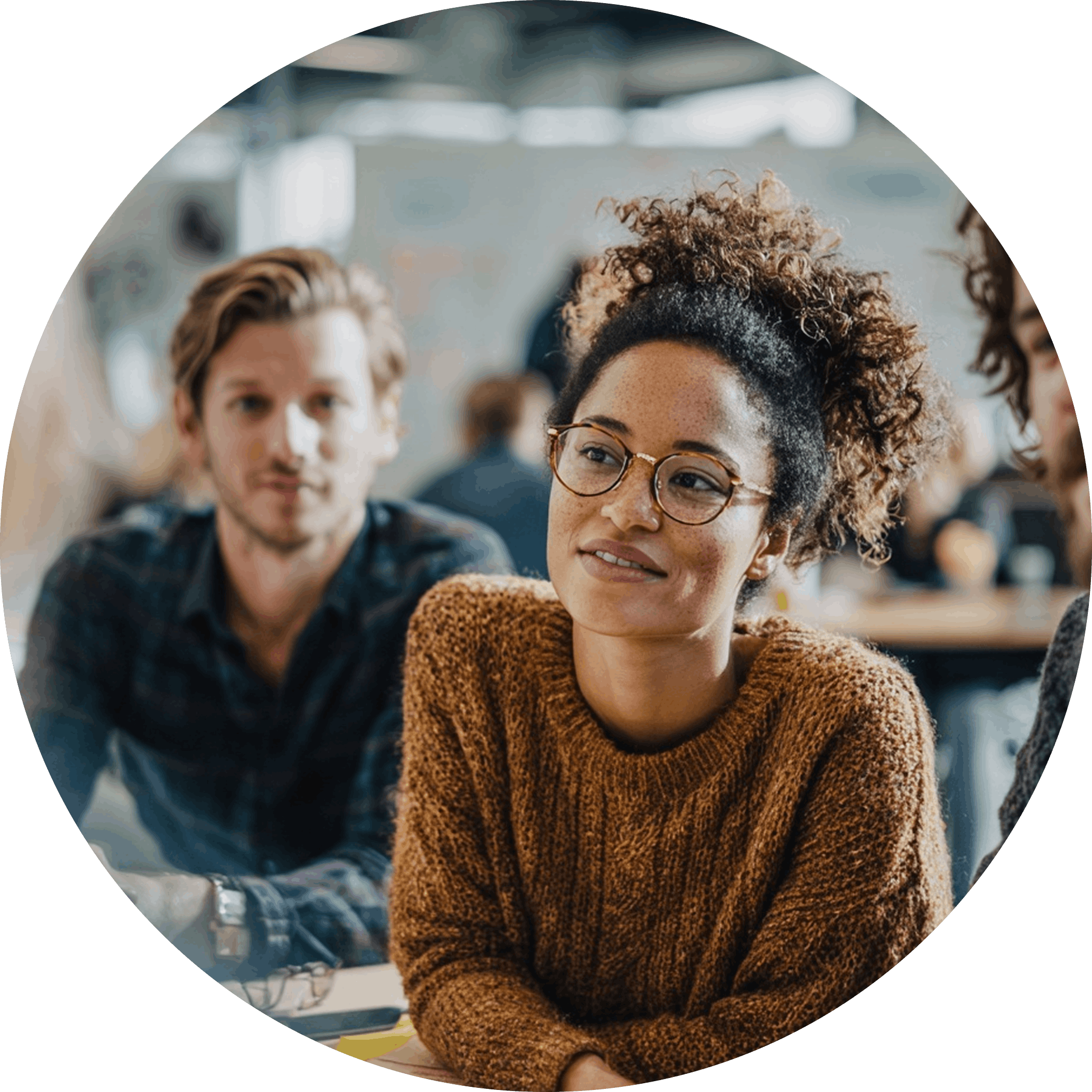 Logan Leads team member with curly hair and glasses collaborating during a strategy meeting in the Toronto office