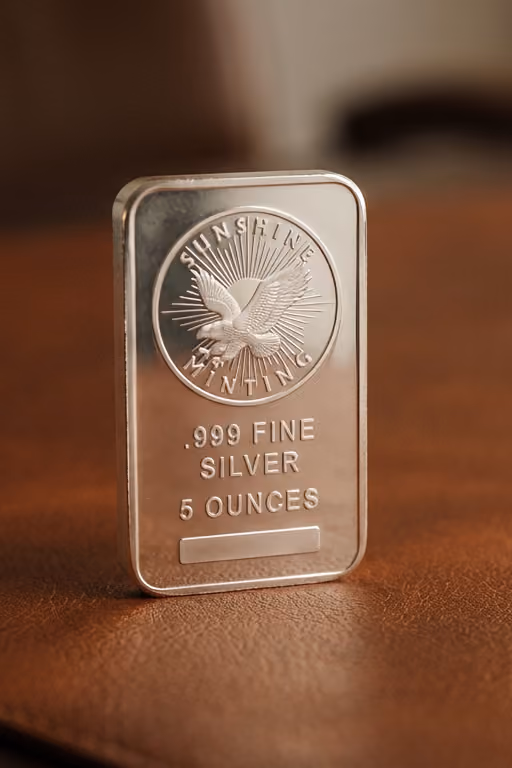 A Sunshine Minting .999 fine silver bar standing upright on a table