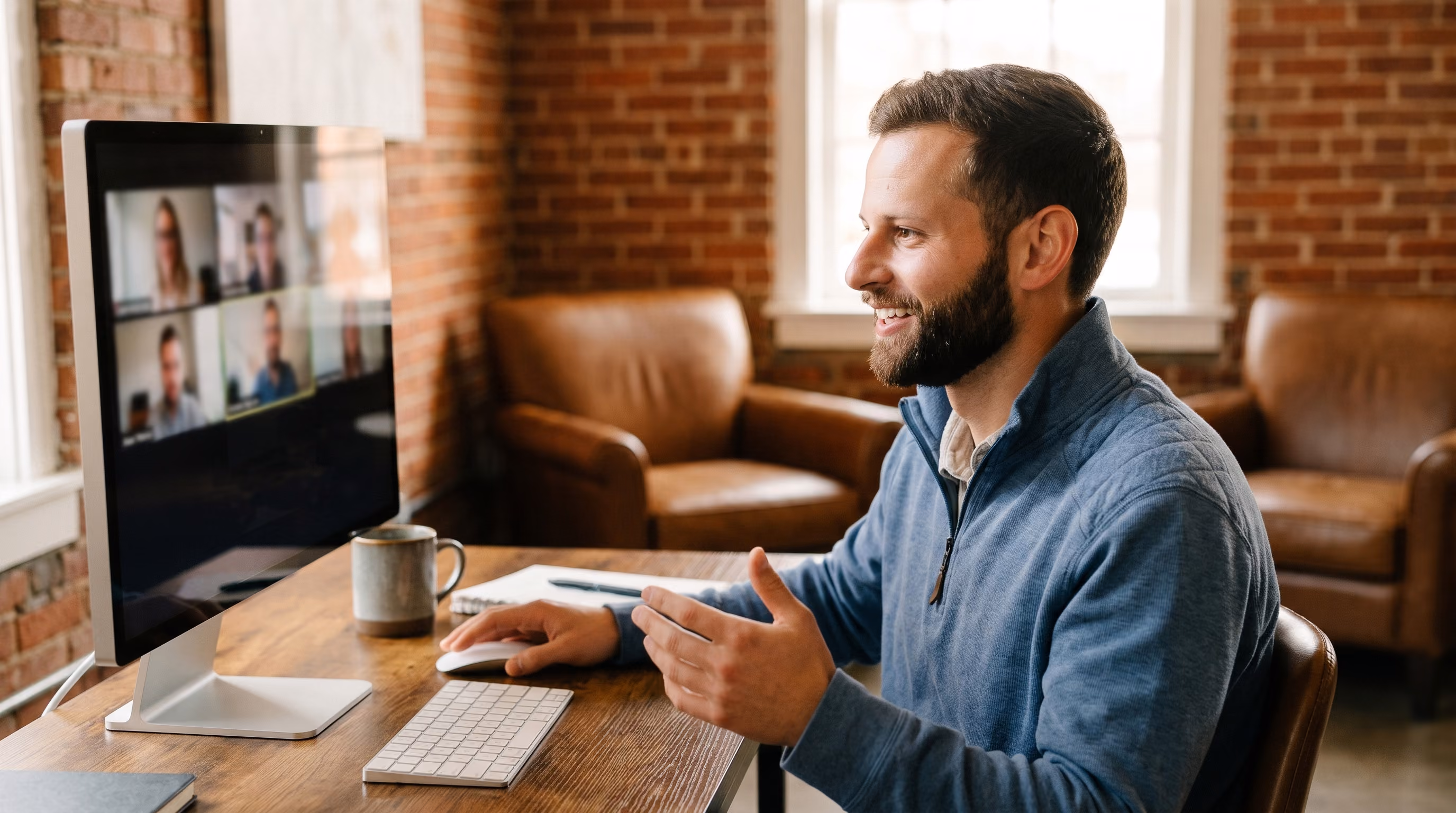 A bearded KEPM team member on a video call at his desk