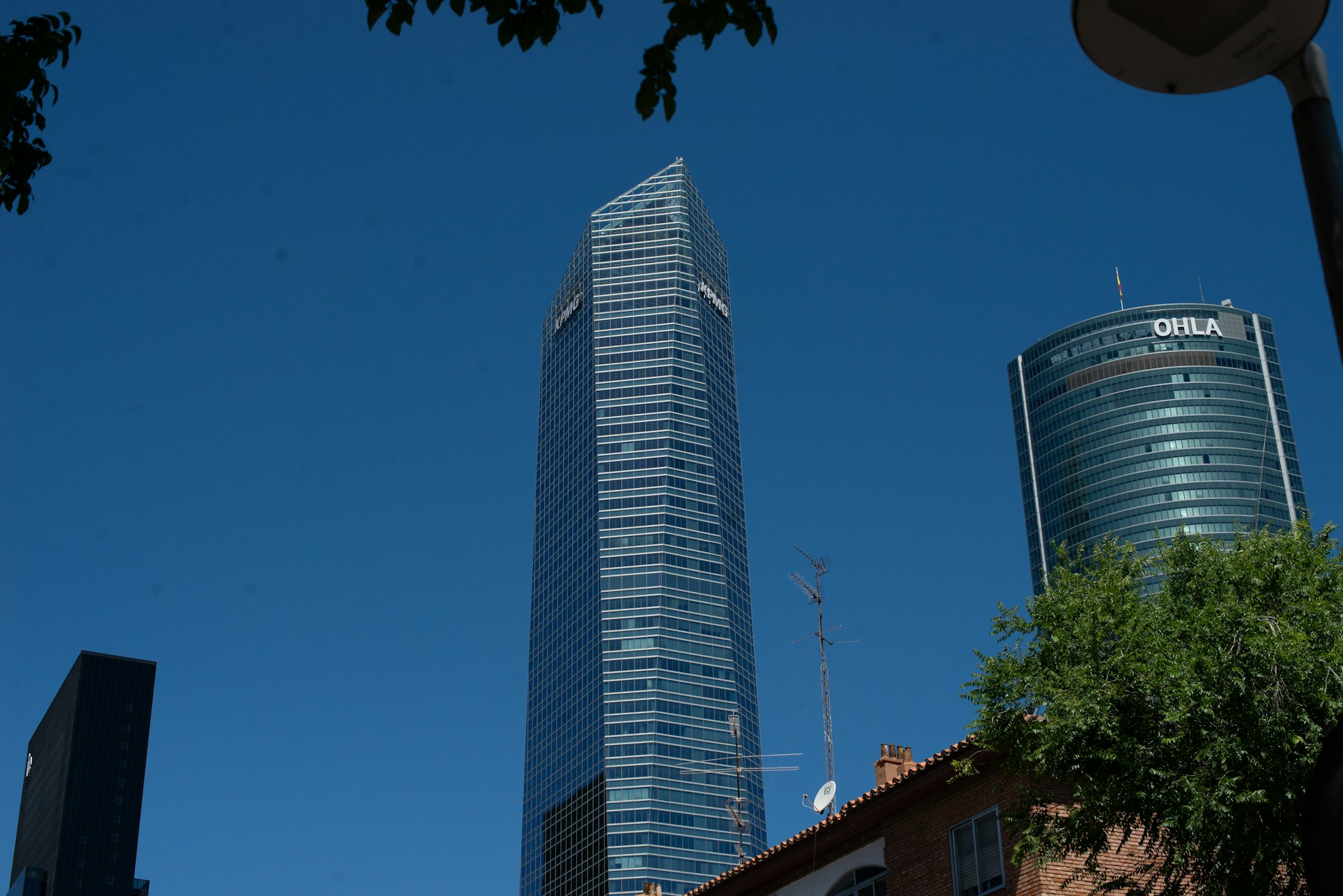 a tall building towering over a city filled with tall buildings