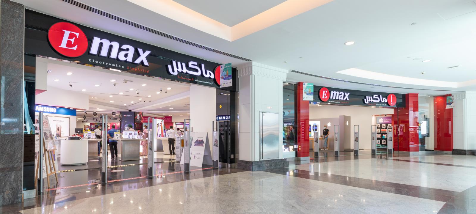 EMAX electronics storefront at Oasis Mall, with illuminated signage and product displays