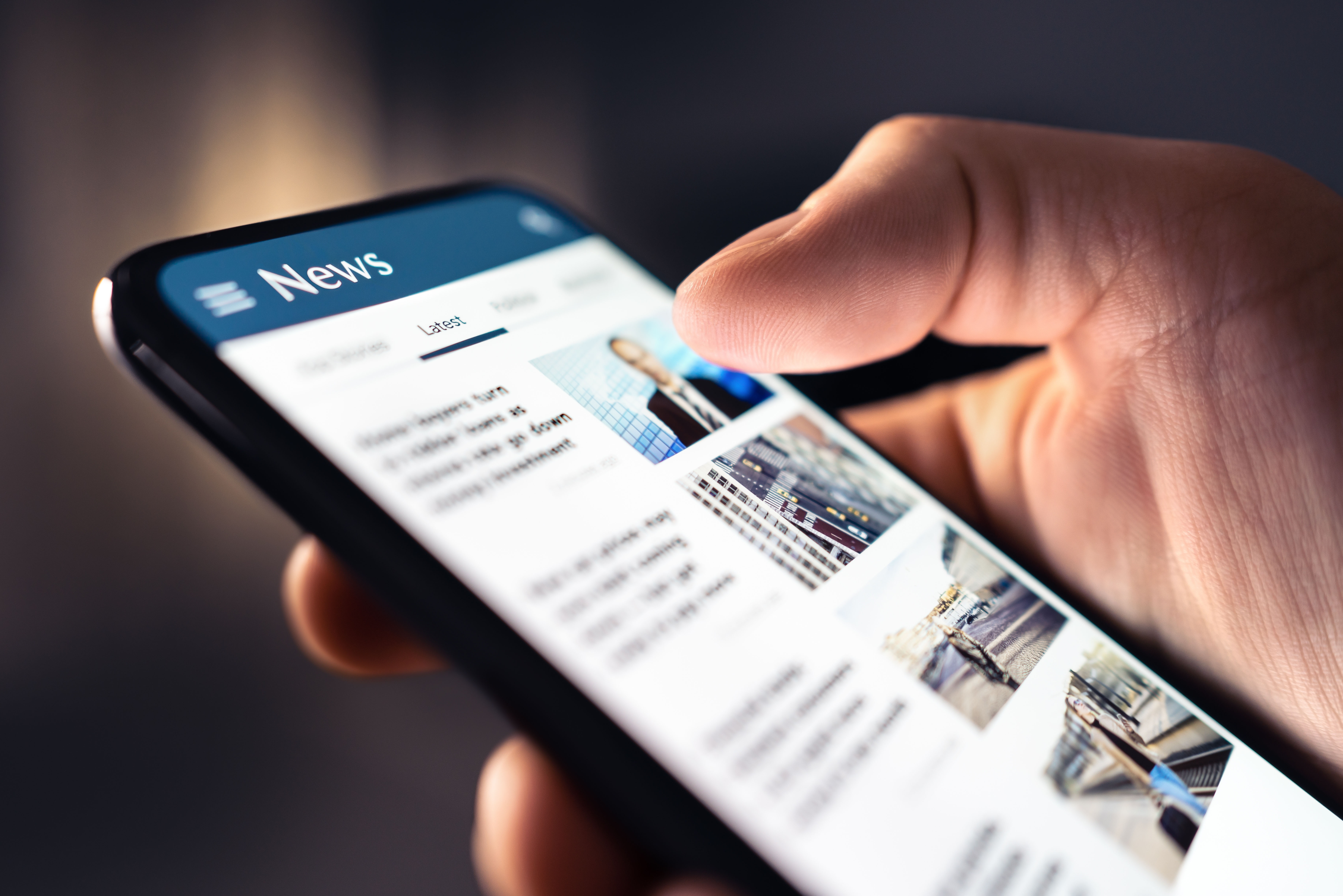Close up shot of a phone displaying the news