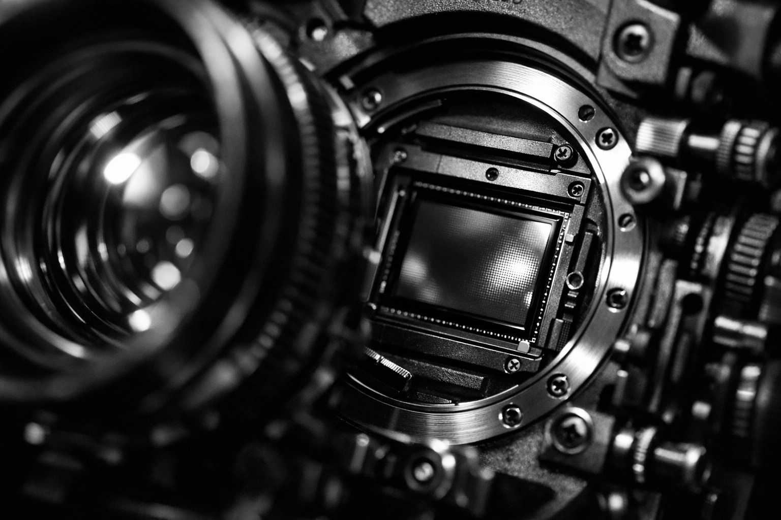 Close-up of professional cinema camera lens showing high-end video production equipment