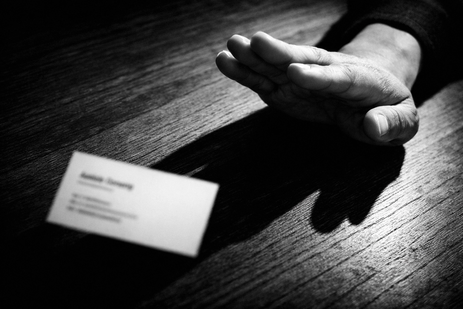 Hand pushing away sales business card representing rejection of traditional selling tactics
