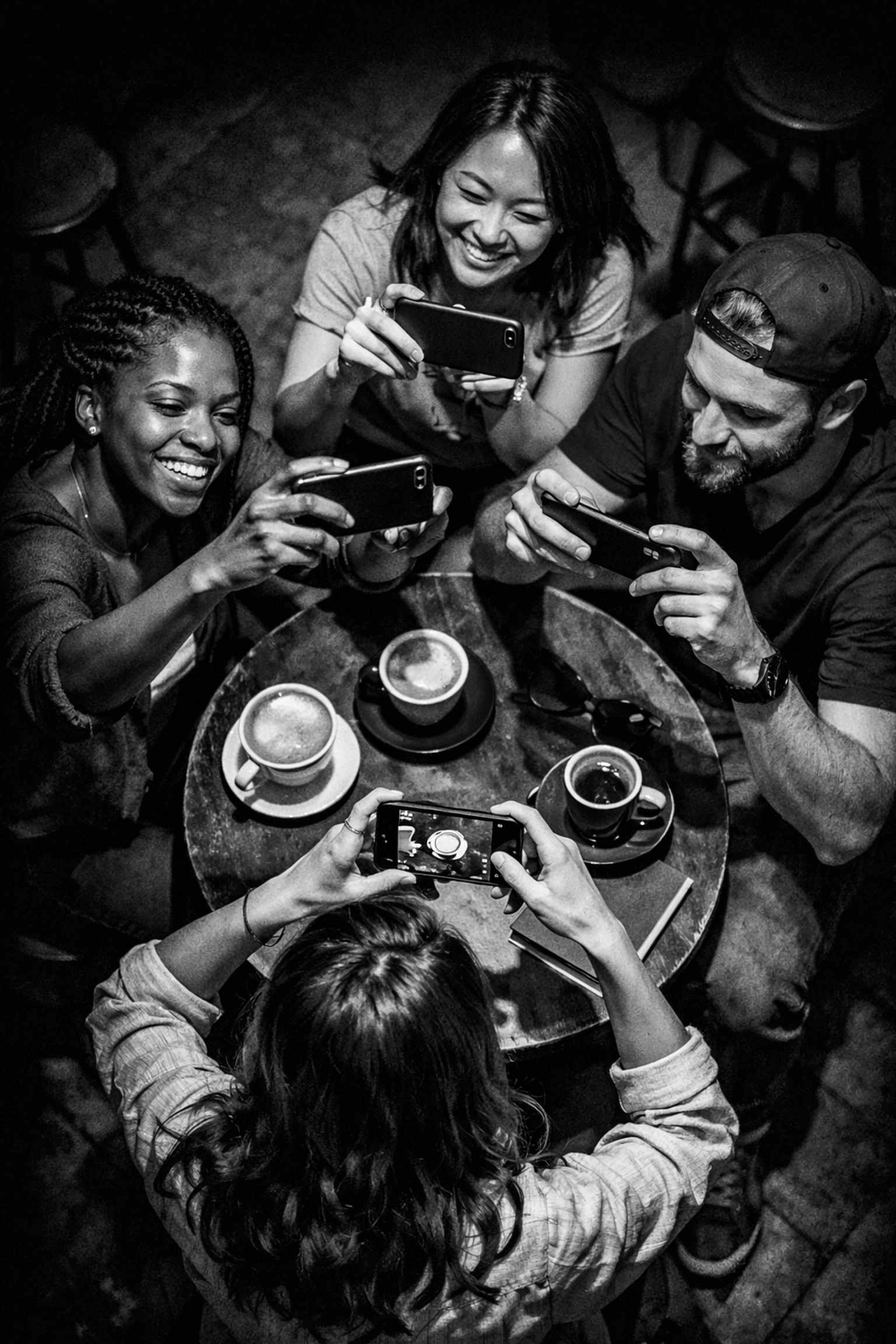 Micro-influencers collaborating and creating content together at coffee shop table