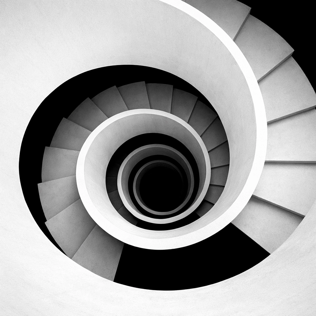 A minimalist spiral staircase symbolizing a seamless and frictionless customer journey to business growth.