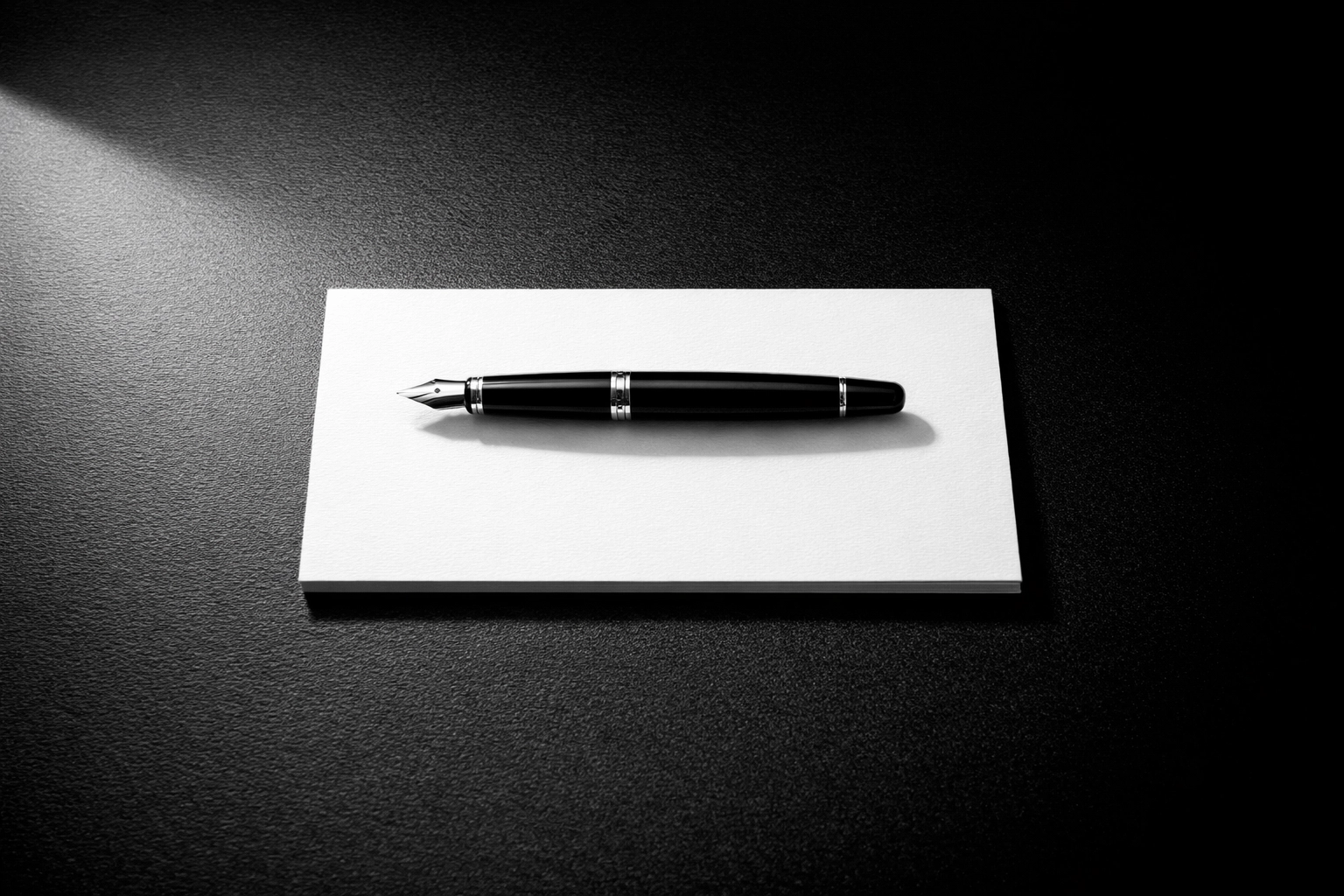 A fountain pen on a blank card, representing a fresh brand strategy and a clear path for business growth.
