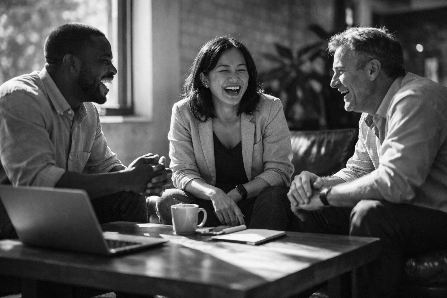 A diverse professional team collaborating in a modern office to build authentic company culture.