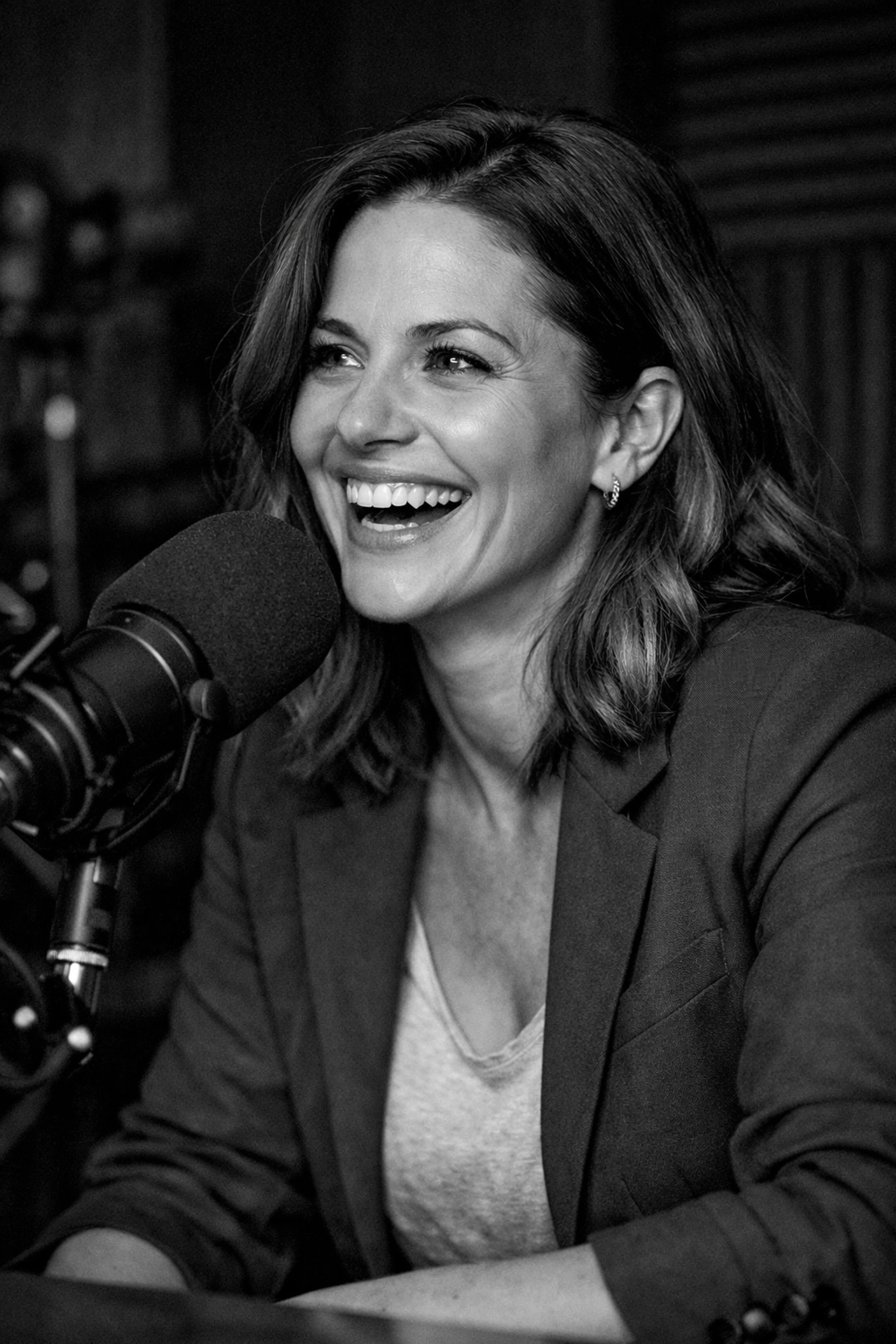 A professional woman recording a podcast to establish authentic human connection with her audience.