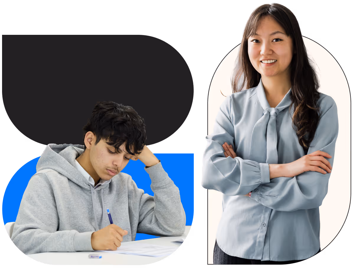 Young man in a gray hoodie writing on paper at a desk while a smiling woman in a light blue blouse stands with her arms crossed nearby.