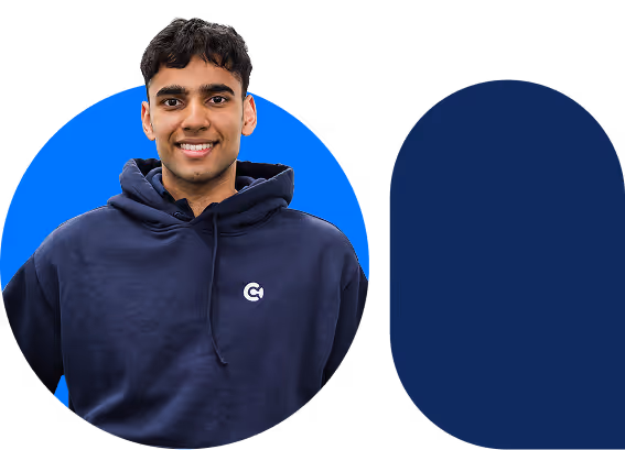 Smiling young man wearing a navy blue hoodie with a logo, against a blue circular background.
