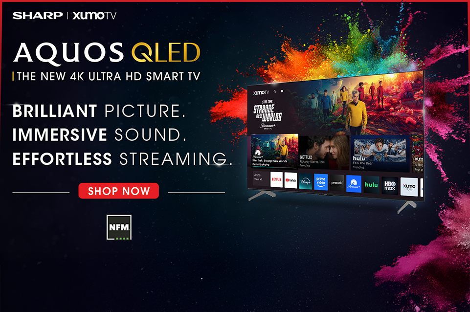 Sharp AQUOS QLED 4K Ultra HD Smart TV advertising with vibrant color splash behind the TV screen showing streaming apps and the message Brilliant Picture, Immersive Sound, Effortless Streaming.