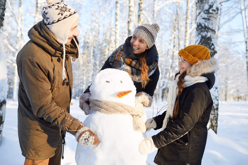 A family building a snowman