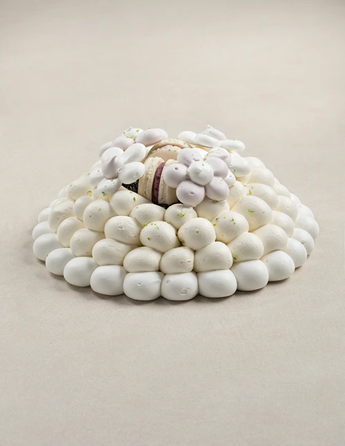 Alt text: Blueberry Pavlova cake with baked meringue, vanilla custard cream, blueberry jam, blueberry macaron, and delicate meringue flowers from VANIL.