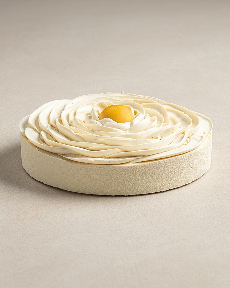 Whole Exotic Cheesecake with cheesecake mousse, mango jam, passion fruit crémeux, and white chocolate velvet finish.