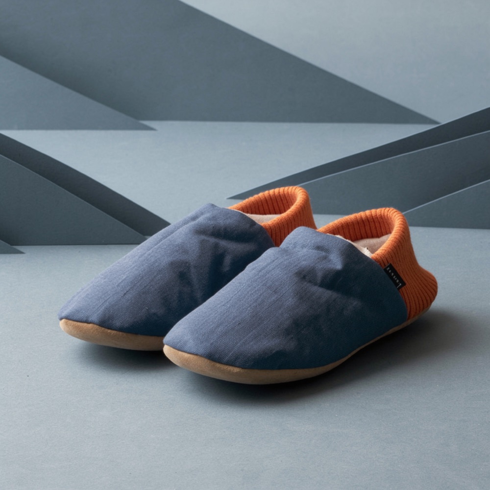 The slippers restyled as a simple paper-set product image, with the blue fabric and orange heel kept.