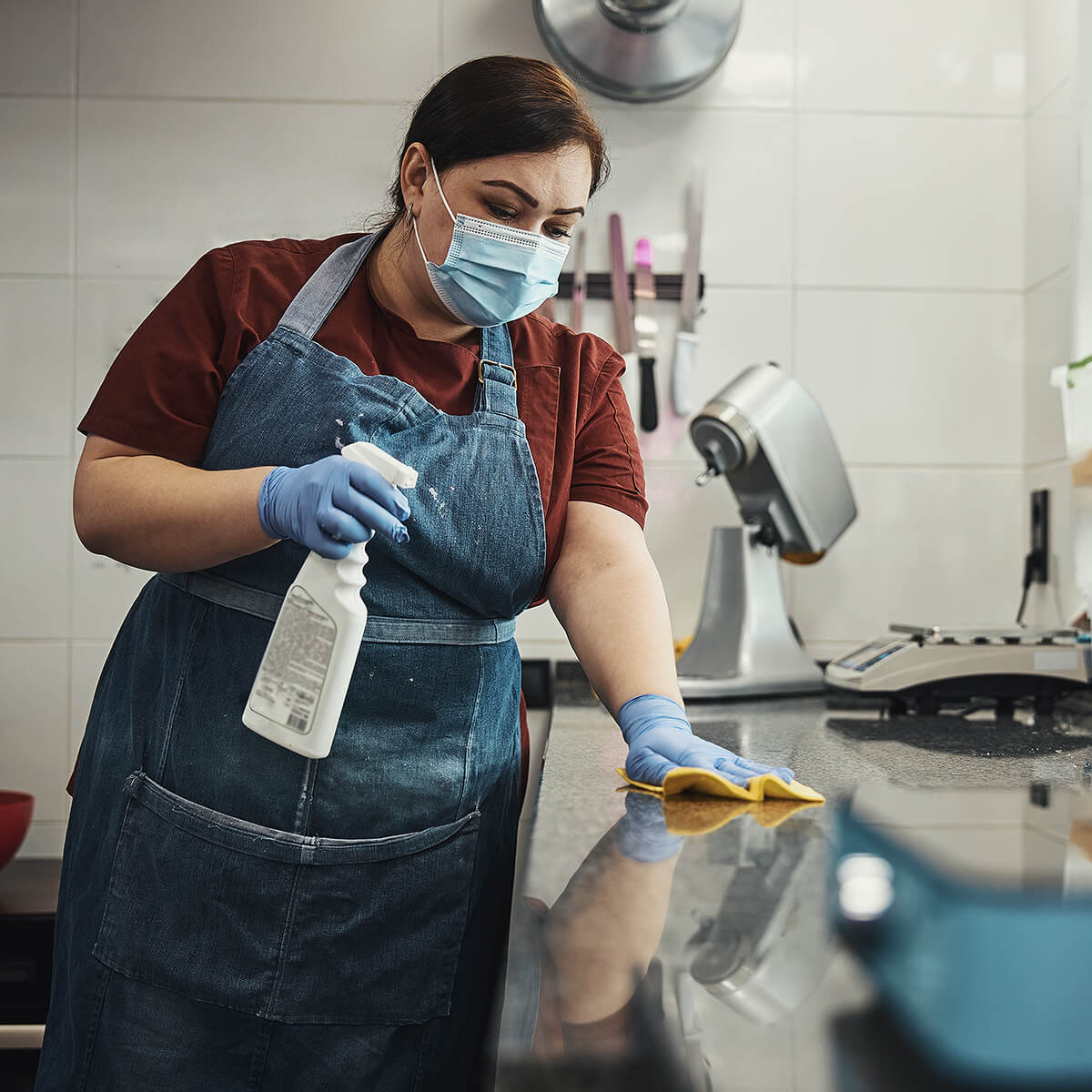 Kitchen staff cleaning commercial kitchen to prevent pests