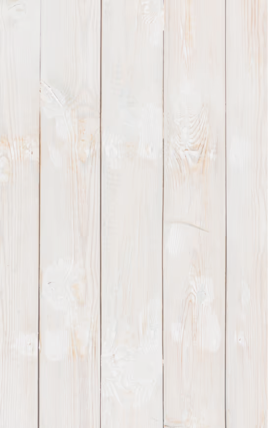 Vertical whitewashed wooden planks with visible natural grain and knots.